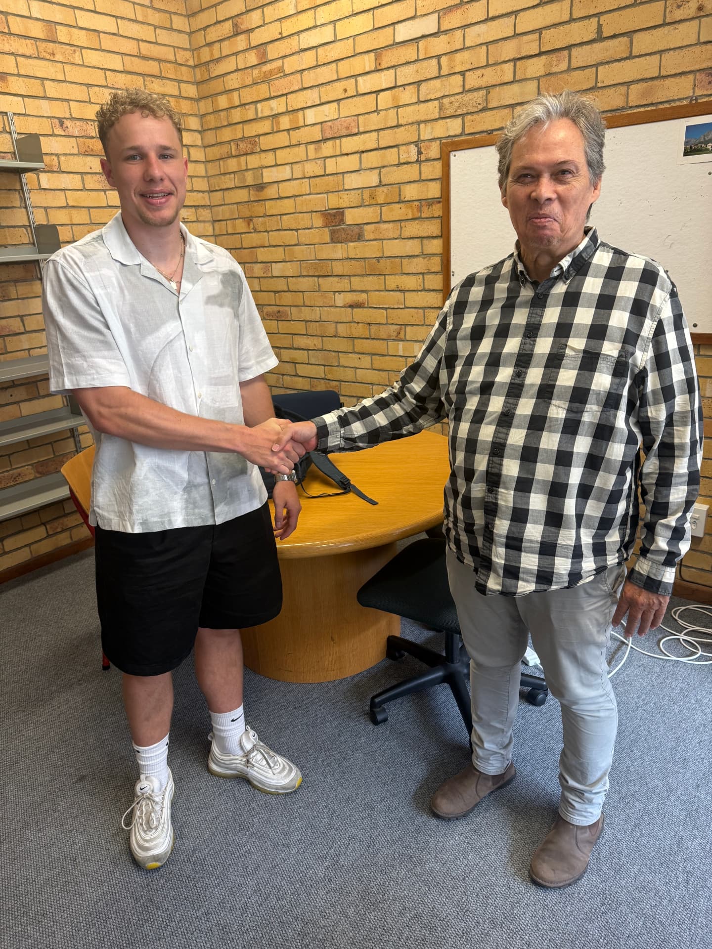 Matteo Buxman shaking hands with a colleague after demonstrating the contactless payment system